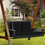 Costway 21476893 2-Person Patio Rattan Porch Swing with Cushions-Black