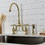 Kingston Brass KS7797TXBS French Country Bridge Kitchen Faucet with Brass Sprayer, Brushed Brass