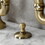 Kingston Brass KS7993TAL Tudor Bridge Bathroom Faucet with Brass Pop-Up, Antique Brass