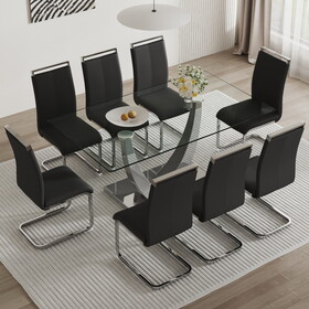 Table and chair set. Large modern rectangular table with glass top and silver metal legs. Furnished with soft and comfortable PU chairs with faux leather upholstered seats and silver metal legs.