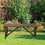 Outsunny 2-Person Wooden Garden Bench, Outdoor Wagon Wheel Porch Bench for Backyard Garden, Support 550 LBS, Rustic Country Style Patio Furniture, Brown