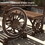 Outsunny Outdoor Table and Chairs for 4 People, Wooden Patio Table and Dining Bench Set, 3 Piece All Weather Furniture Set with Wagon Wheel Design for Backyard Garden, Deck, Carbonized